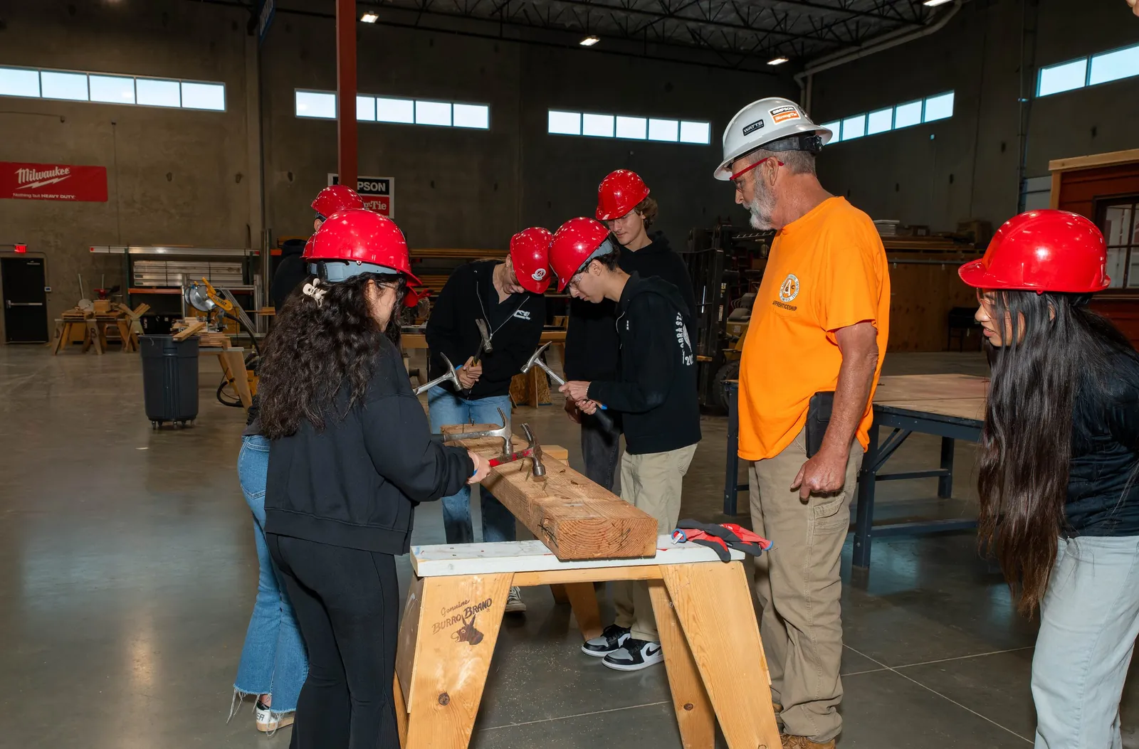 Students working around a bench with an instructor in a training-centre workshop